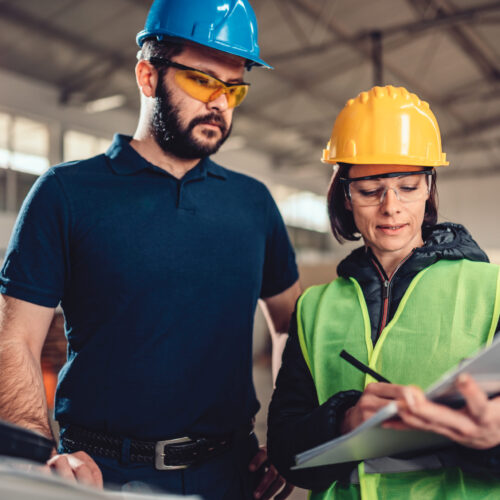 Quality Control Process Inspector writing a report Quality Control Process Inspector writing a report in industrial factory
